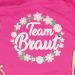 Blumenkranz-Motiv mit Team Braut-Schriftzug auf pinkfarbenem Stoffbeutel